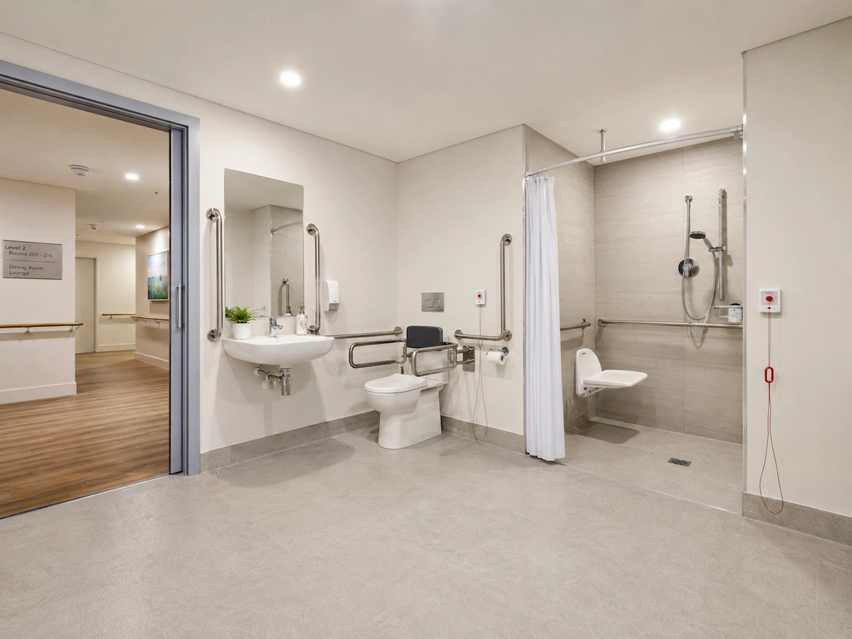 Accessible assisted bathroom aged care facility Sydney by Building Project Solutions, grab rails to AS 1428.1, fold-down shower seat, emergency call system with two call points